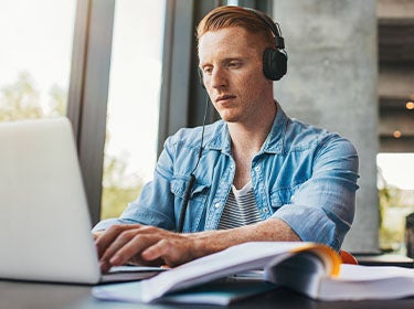 Male student looking at a computer