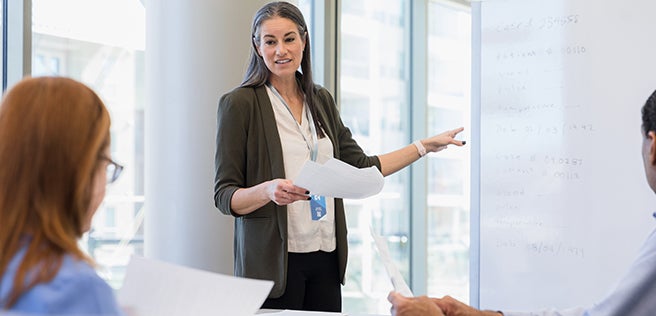 Woman standing in front of room teaching