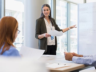 Woman standing in front of room teaching