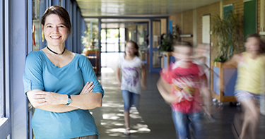 Woman smiling standing in school hallway