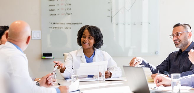 Group of doctors talking around a table