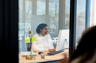 Woman sitting working on computer