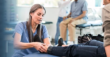 Nurse adjusting a person's ankle