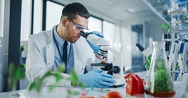 Man looking into microscope