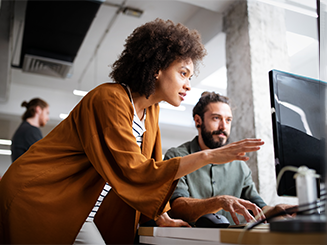 Woman pointing to computer screen