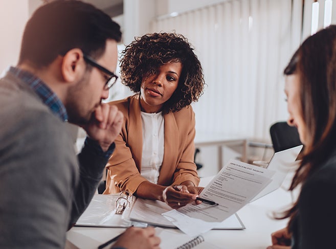 Woman working in paperwork with couple