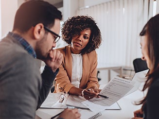 Woman working in paperwork with couple