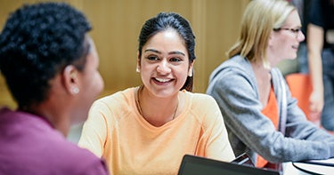 Girl smiling at another student
