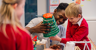 Teacher helping student with science experiment