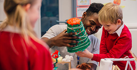 Teacher helping student with science experiment
