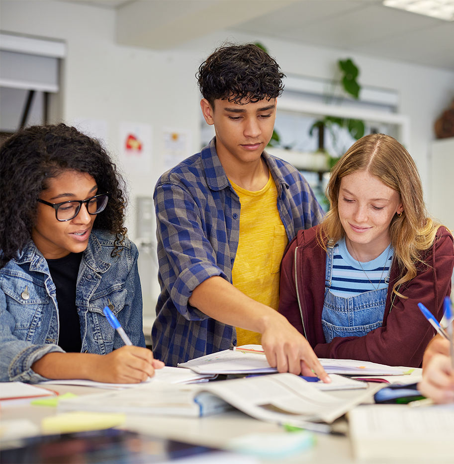 Students at a table working on homework together.