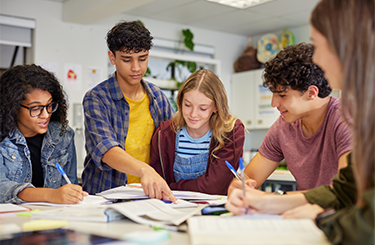 Students at a table working on homework together.