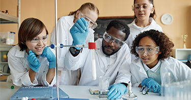 Children conducting a science experiment with teacher